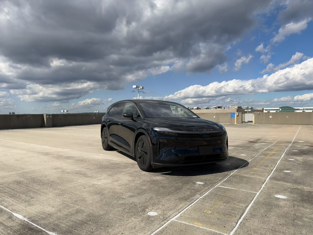 Cyp's black Lucid Gravity on a rooftop parking deck under a cloudy sky